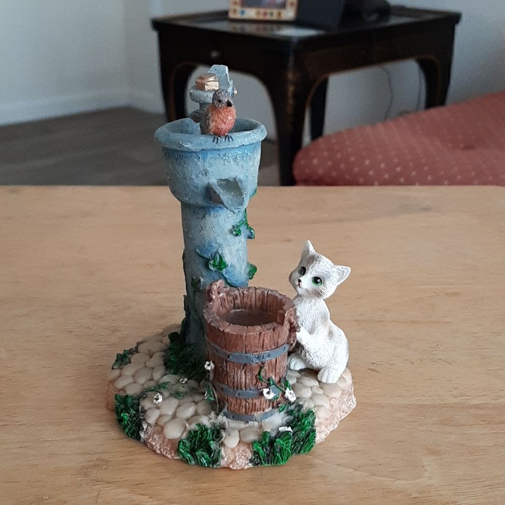 Vintage Home Interiors & Gifts figurine with cat, bird, barrel, and water pump